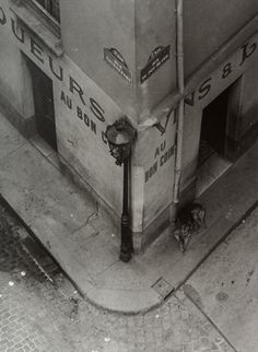 an old black and white photo of the corner of a building