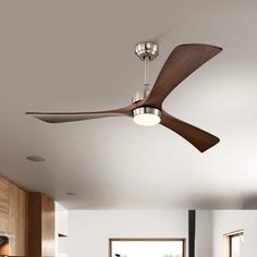 a ceiling fan that is hanging from the ceiling