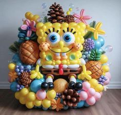 the balloon sculpture is made to look like spongebob with pineapples and other decorations