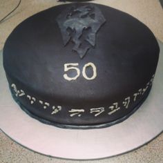 a black cake with white writing on it