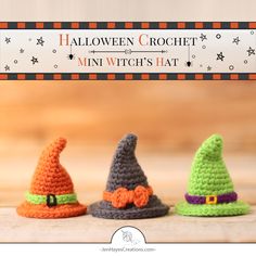 three crocheted witches hats sitting on top of a wooden table next to a sign that says halloween crochet mini witch's hat