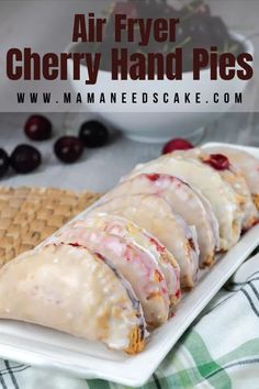 an air fryer cherry hand pies on a plate with cherries in the background