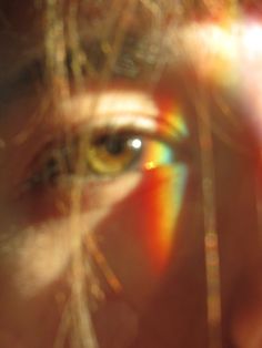 a woman's eye is seen through the lens of her cell phone, with blurry lines in the foreground