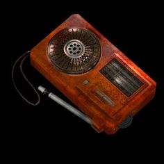 an old fashioned radio sitting on top of a wooden table next to a black background