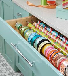 an open drawer in a kitchen filled with ribbons