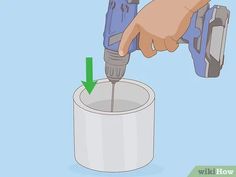 an electric drill is being used on a roll of toilet paper with a green arrow pointing to it