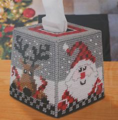 a tissue dispenser decorated with santa claus and reindeer