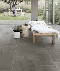 an outdoor patio with stone flooring and furniture