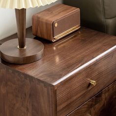 a wooden table with a lamp and radio on it