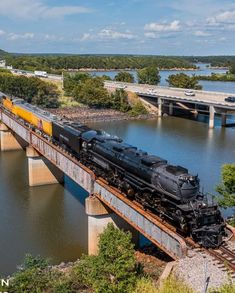 a train traveling across a bridge over a river