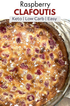 image of keto raspberry clafoutis in a pie tin and topped with sugar-free powdered sweetener