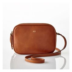 Whether you're traveling, running errands or commuting to work, a compact crossbody is a must-have. With a classic design, beautifully soft leather and an adjustable shoulder strap, the Essential Crossbody makes the perfect gift for yourself or your favorite person.    8"w x 2.5"d x 6"h  Leather, linen lining.  Imported.  Monogramming can be foil debossed or printed. Classic Everyday Satchel Camera Bag, Classic Satchel Camera Bag For Everyday Use, Classic Soft Leather Camera Bag For Travel, Classic Crossbody Camera Bag For Travel, Soft Leather Crossbody Camera Bag For Travel, Classic Smooth Grain Shoulder Bag For On-the-go, Classic Camera Bag For Daily Use, Classic Brown Camera Bag With Adjustable Strap, Classic Camera Bag With Adjustable Strap