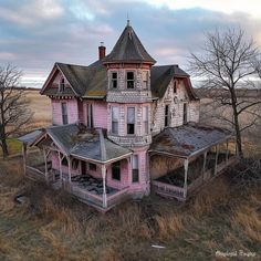 an abandoned pink house in the middle of nowhere