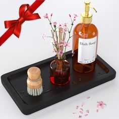 a bottle of soap and brush on a tray