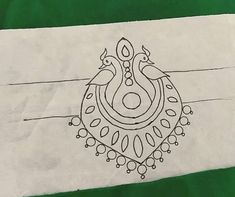 a drawing of two birds sitting on top of a green and white paper bag with an ornamental design