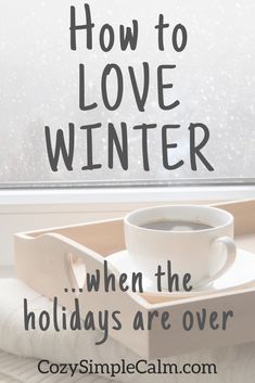 a cup of coffee sitting on top of a tray with the words how to love winter