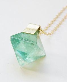 Featuring a beautiful pyramid shaped Blue Fluorite Stone which was hand framed into a 14k gold filled pendant. This necklace highlights the beautiful elements of this arresting stone. The stone measures approx. 15mm wide and hangs from 18" 14k gold filled chain.  Please note: Each stone can vary in blue color, cube shape and range between smooth to uneven surface. Green Fluorite Crystal Necklace, Unique Faceted Jewelry For Gifts, Green 14k Gold Spiritual Necklace, Spiritual Green 14k Gold Necklace, Unique Green Faceted Jewelry, Unique Faceted Green Jewelry, Green Spiritual Jewelry With Natural Inclusions, Spiritual Green Jewelry With Natural Inclusions, Unique Emerald Necklace As Gift