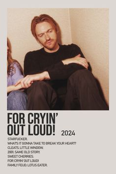 a man and woman sitting next to each other in front of a wall with the words for cryin'out loud on it