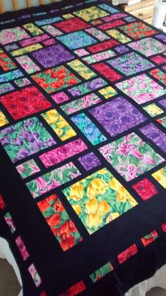 an image of a quilt that has been made with different colors and designs on it