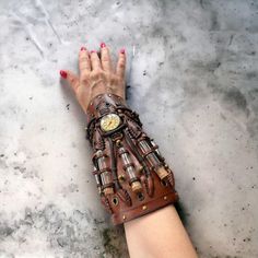 This steampunk brown cuff was made to order for a cosplay event. We created it from scratch.  The watch used in the design will be replaced by something similar because we had only one piece.   The bracelet was made of genuine cow leather and decorated with glass vials and various metal parts following the steampunk style.  The bracelet's width is about 20 cm (7.9 in) It can be personalized to your size. So, please leave your measurements at the checkout. Please measure your wrist to get the pro Brown Punk Leather Bracelet For Gift, Handmade Brown Steampunk Jewelry, Steampunk Leather Bracelet As A Gift, Steampunk Leather Bracelet Perfect As A Gift, Handmade Punk Leather Bracelet As Gift, Adjustable Steampunk Leather Bracelet, Gothic Leather Bracelet As Gift, Gothic Leather Bracelet Gift, Gothic Leather Bracelet