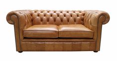 a brown leather couch sitting on top of a white floor