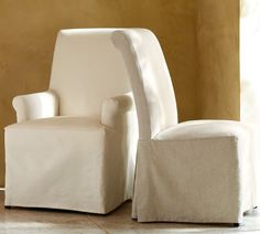 a white chair and footstool sitting next to each other