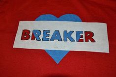 a red shirt with the word breaker on it and a blue heart in the center