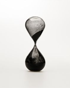 an hourglass sitting on top of a white table