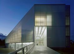 an empty walkway leading to a large building