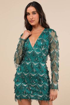 Charm your way through the evening in the Lulus Playful Composure Green Fringe Sequin Mini Dress! Lightweight mesh boasts a gold-toned sequin design and fun fringe details as it shapes long sleeves and a bodice with seamed cups and a V-neckline. Figure-skimming skirt ends at a mini hem. Hidden zipper/clasp at back. Fit: This garment fits true to size. Length: Mid-thigh. Size medium Bust: Great for any cup size. Waist: Fitted - very fitted at natural waist. Hip: Fitted - consider sizing up for fu Outfits For New Years Eve, Mini Dress Mesh, Homecoming Dresses Sparkly, Fringe Mini Dress, Long Sleeve Sequin Dress, Dress With Sequins, Sequin Design, Different Dresses, Green Sequins