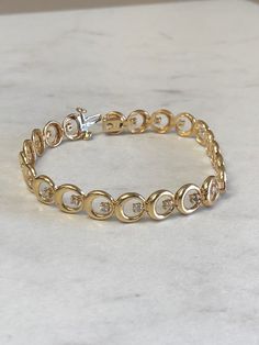 "14kt Yellow Gold Lady's Diamond 7\" Bracelet consisting of 22 full cut round brilliant diamonds 1/2ct total weight SI2 clarity, H color all set in 4 prong low base heads soldered inside bright polished custom made circles all hinged for maximum flexibility and comfortable movement. This well made diamond bracelet has a heavy hidden style clasp. You can be proud to wear this day after day either casual or formal for a grandeur look of elegance. The weight of the bracelet is 12.15 grams. This ite Anniversary Diamond Bracelet With Brilliant Cut, Timeless Round Gold Bracelet With Prong Setting, Timeless Gold Bracelet With Prong Setting, 14k Yellow Gold Diamond Bracelet, Classic Round Diamond White Gold Bracelet, Yellow Gold Diamond Bracelet With Prong Setting, Anniversary Gold Bracelet With Brilliant Cut Diamonds, Classic Round Gold Bracelet With Diamond Accents, Classic 14k Gold Diamond Bracelet