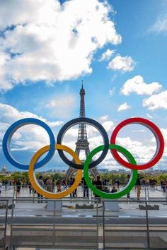 the olympic rings in front of the eiffel tower