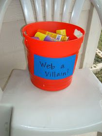 a plastic bucket filled with candy sitting on top of a white chair