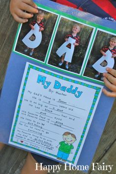 a young boy holding up a poster with pictures of his daddy