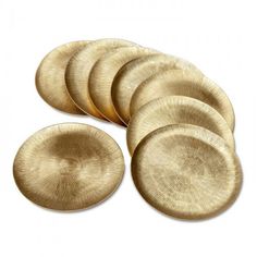 six gold plates sitting on top of each other