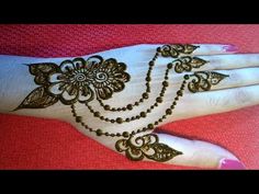 a woman's hand with henna tattoos on it