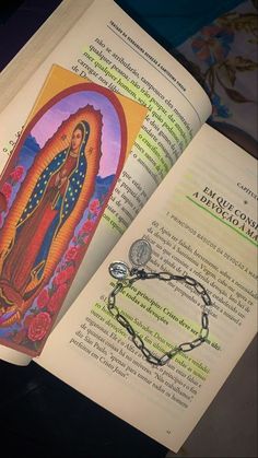 an open book with the image of our lady of guadalupe on it's cover