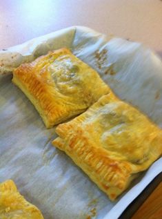 three pastries sitting on top of a baking sheet