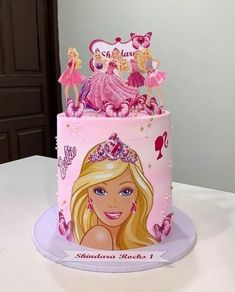 a birthday cake with barbie dolls on it