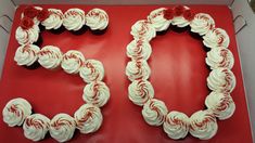 two heart shaped cupcakes with white frosting and red roses