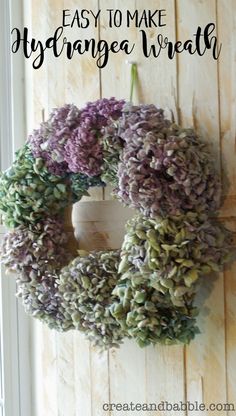 a wreath hanging on the side of a door with text overlay that says easy to make hydrangea wreath