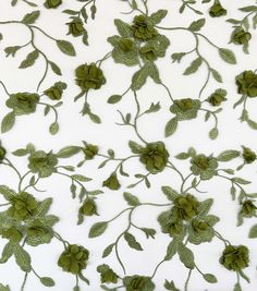 green flowers and leaves on white fabric