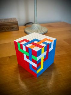 a colorful cube sitting on top of a wooden table