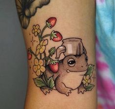 a tattoo with a squirrel and flowers on it