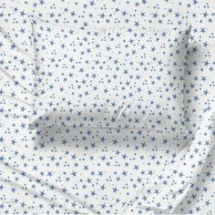 a white sheet with blue stars on it and the sheets are folded up in half