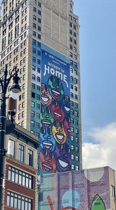 an advertisement on the side of a tall building in front of a city street light