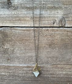 "Geometric Necklace, Delicate, Art Deco, Architectural, Urban, Modern, Minimalist Make a simple and unique statement with a modern geometric necklace. Smooth concrete tetrahedron shape is paired with a gold plated, geometric shape, creating a symbiotic balance. Brass chain is paired with a gold plated chain creating an ombre effect. Length of Brass Chain: 24\" Necklace will be placed in a cloth bag- ready for gifting!" Minimalist Triangle Metal Necklace, Minimalist Geometric Metal Necklace, Minimalist White Triangle Jewelry, Handmade Minimalist Geometric Jewelry, Minimalist Handmade Geometric Jewelry, Minimalist Triangle Brass Jewelry, Minimalist Geometric Necklaces For Everyday, Concrete Necklace, Smooth Concrete