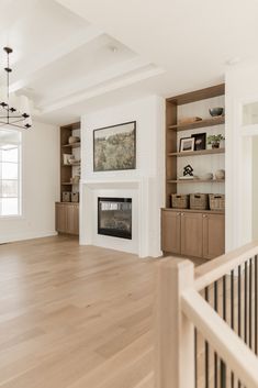 an empty living room with white walls and wood floors