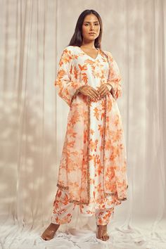 Burnt orange bell sleeves A-line kurta with all over floral print. Paired with a matching printed pant and a dupatta with gold trim lace detailing on the borders. - Aza Fashions Navratri Orange Anarkali Set With Printed Motifs, Festive Orange Palazzo Set With Straight Kurta, Orange Palazzo Set With Sheer Dupatta For Diwali, Festive Orange Anarkali Set With Printed Motifs, Festive Orange Palazzo Set With Printed Motifs, Orange Straight Kurta With Dabka, Orange Anarkali Set With Printed Motifs, Orange Dabka Straight Kurta, Festive Orange Palazzo Set With Sheer Dupatta