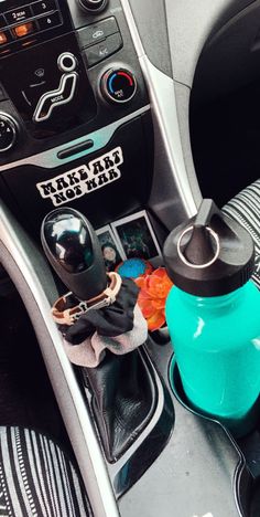 the interior of a car with various items on the console and steering wheel knobs